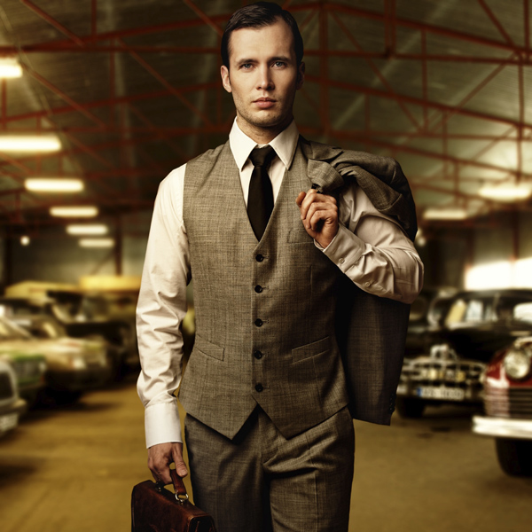 Businessman with a briefcase in garage
